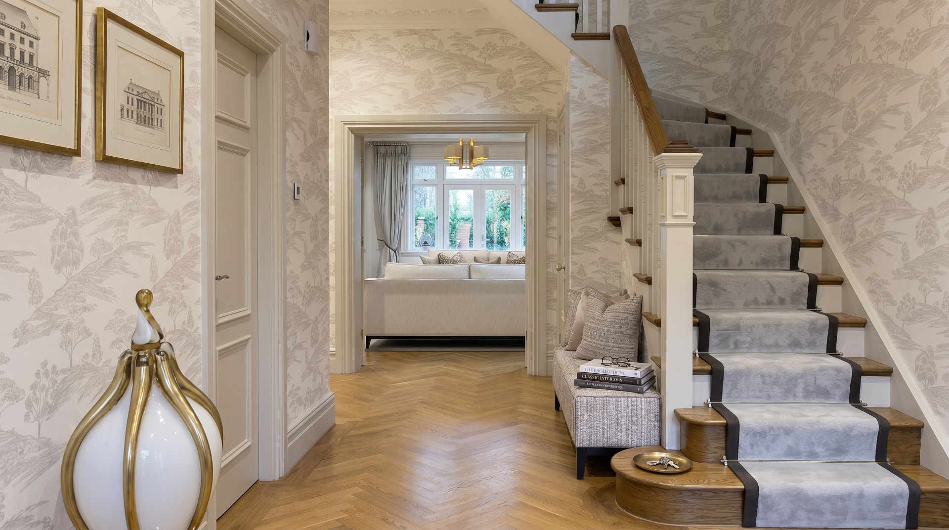 Entrance hallway with toile wallpaper, herringbone floor and grey stair runner — Winkfield, Berkshire